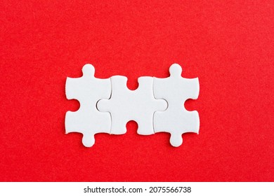 Three Puzzle Pieces On Red Background.