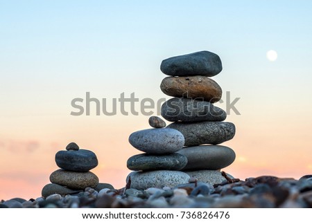 the three pyramids of stones stacked on top of each other, the sea beach of the Black sea