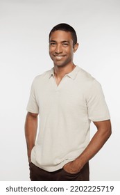 Three Quarter Length Shot Of Attractive Black Man In His 40s Posing Casually And Smiling On White Background