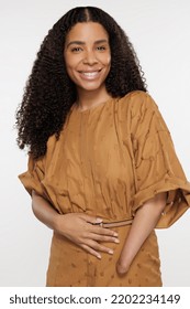 Three Quarter Length Shot Of Beautiful African American Woman In Her 30s With Gorgeous Hair Posing Confidently On White Background