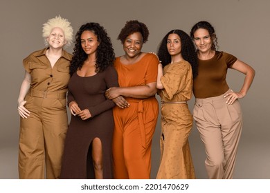 Three quarter length shot of a group of beautiful multiracial women standing confidently on a neutral background. Stock Photo