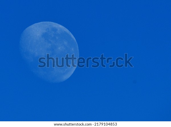three quarter moon in\
daylight