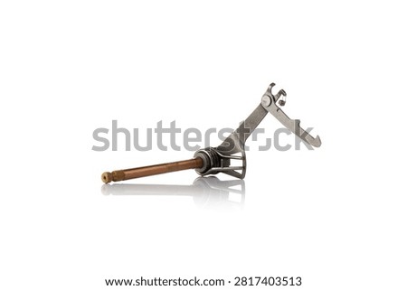 Three quarter perspective studio view of complete motorcycle gear shift shaft assembly featuring bronze plated splined rod, steel selector arm linkage, return torsion spring, and ratchet pawl, shot on reflective white background showcasing powertrain transmission repair hardware.