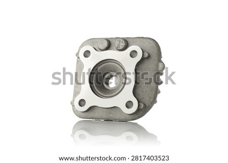 Three quarter perspective view of cast aluminum alloy two stroke engine cylinder head featuring machined mating surface, central spark plug port, internal hemispherical combustion chamber, and cooling fins, professional studio product photography shot on reflective white background showcasing scooter motor parts.
