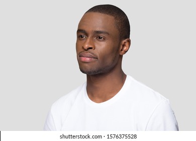 Three Quarter Portrait Of Attractive Confident Millennial African American Man, Handsome Young Male Wearing White T-shirt, Serious Guy, Student Posing Close Up Isolated On Studio Background