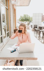 Three Quarter View Of Female Working Outside Drinking Coffee