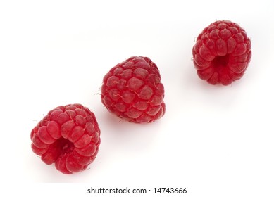 Three raspberry on white background. Close up.