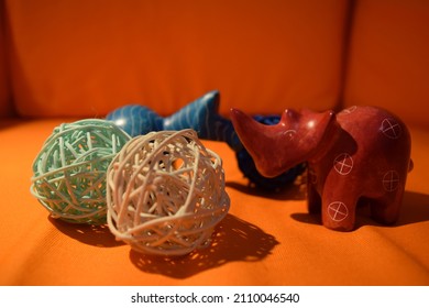 Three rattan balls on top of orange canvass using Nikon D3300  with rhino and elephant 