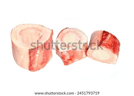 three raw beef marrow bones isolated on white background