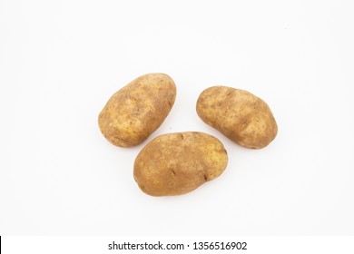 Three raw russet potatoes isolated on white background - Shutterstock ID 1356516902