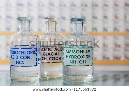 Three reagent bottles containing hydrochloric acid, ammonium hydroxide, and acetic acid.
