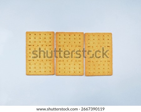 Three rectangular crackers arranged neatly on white background.