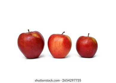 Three red apples in different sizes. Concept of comparison, growth, and natural variation in fruit