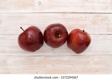 Three Red apples on whitewashed wood table background