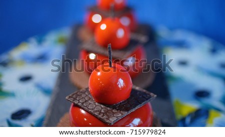 Three red cake with biscuits and chocolate. Tasty red cakes on background dark blue