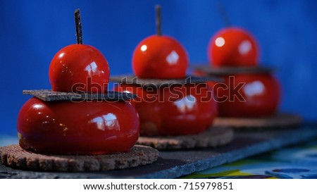 Three red cake with biscuits and chocolate. Tasty red cakes on background dark blue