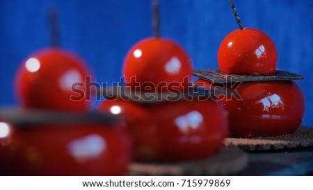 Three red cake with biscuits and chocolate. Tasty red cakes on background dark blue