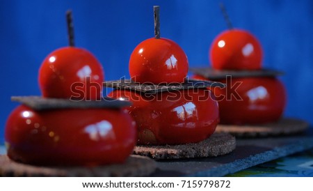 Three red cake with biscuits and chocolate. Tasty red cakes on background dark blue