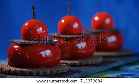 Three red cake with biscuits and chocolate. Tasty red cakes on background dark blue