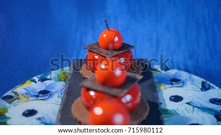 Three red cake with biscuits and chocolate. Tasty red cakes on background dark blue