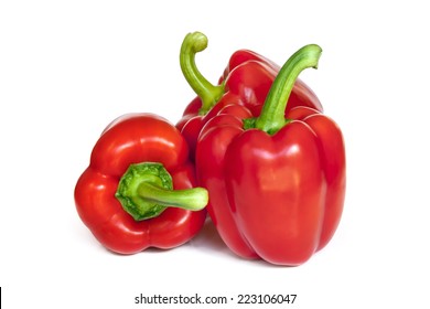 Three red capsicum isolated on white background.  Delicious bell peppers.