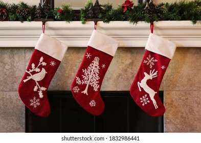 Three red christmas stockings on fireplace mantle - Powered by Shutterstock