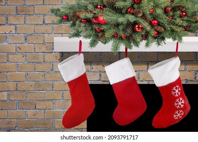 Three Red Christmas Stockings On Fireplace Mantle