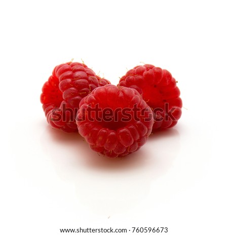 Three red raspberries isolated on white background
