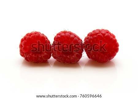 Three red raspberries in row isolated on white background
