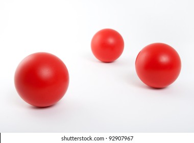 Three red rubber balls isolated on white background.