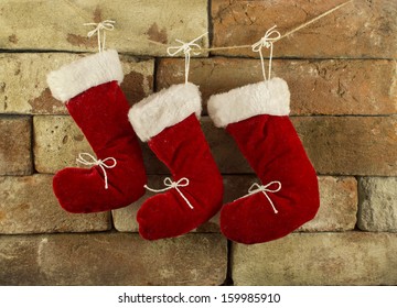 Three Red Santa Boots On Chimney Place Background