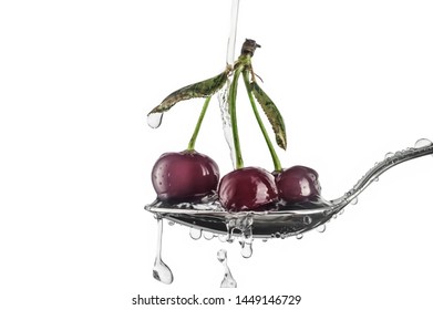 Three Red Sweet Cherry Berries In A Tablespoon With Drops Of Water In A White Background In Horizontal Format