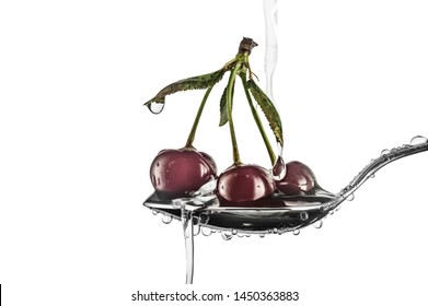 Three Red Sweet Cherry Berries In A Tablespoon With Drops Of Water In A White Background In Horizontal Format