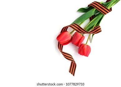 Three red tulips with St. George ribbon isolated on white background. Victory day or Fatherland defender day.