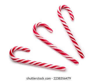 Three red and white striped candy canes for christmas holiday season, sweet treats and festive decorations, they represent festive decorations and delicious confectionery for winter celebrations