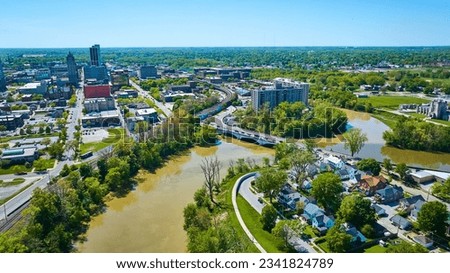 Three Rivers intersecting in Fort Wayne Indiana with houses, bridge, train tracks, skyscrapers