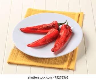 Three Roasted Red Peppers On A Plate