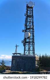 Three Rock TV Transmitter Antenna Viewed From Fairy Castle (Two Rock Mountain), Dublin Mountains, Ireland. Single Cellular Tower Top In Against Clear Blue Sky. Vertical View