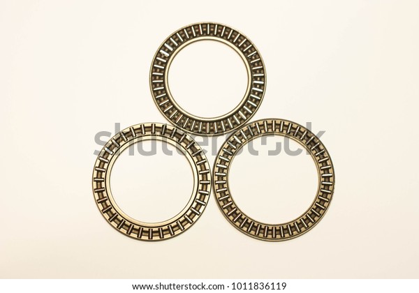 three roller\
bearings on a white\
background
