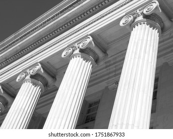 three roman ionic columns under view