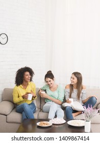 Three Roommates With Coffee Cups Spending Time Together, Sitting At Home