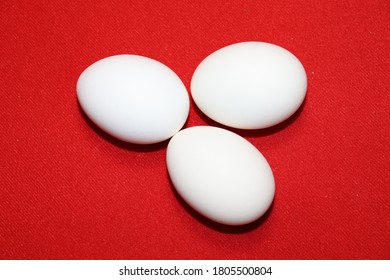 Three Round Eggs On A Red Doily With A Closeup
