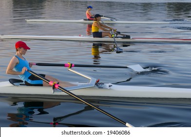 three rowers competing. - Powered by Shutterstock