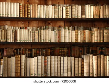 Three Rows Of Old Books On A Shelf