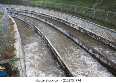 Three Rows Of Sand Trap Basin With Flowing River Water On It