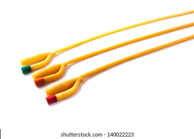 three rubber foley catheters isolated over a white background
