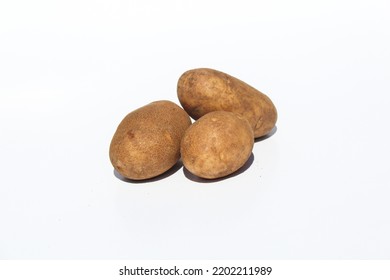 Three Russet Potatoes Isolated On A White Background Ready To Prepare For Cooking