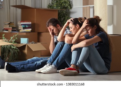 Three Sad Evicted Roommates Moving Home Complaining Sitting On The Floor