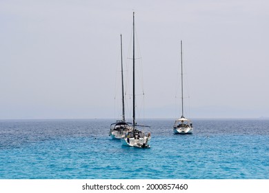 Three Sail Boats In The Turquoise Water.