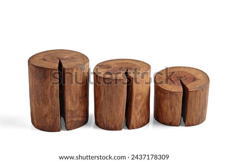 Three sawed tree trunks with a crack isolated on a white background. Podiums for product advertising of different heights.
